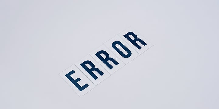 A-white-sheet-paper-with-the-word-error-written-in-navy-blue.