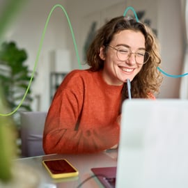 Skills Bootcamp imagery of young woman smiling at laptop