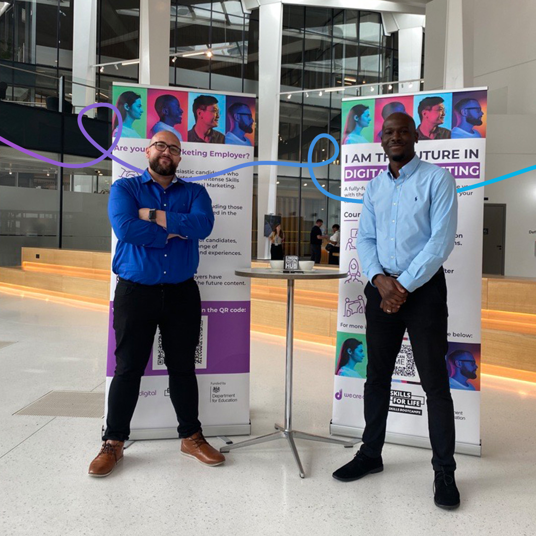 Photo of our Employer Engagement Team standing in front of event banners