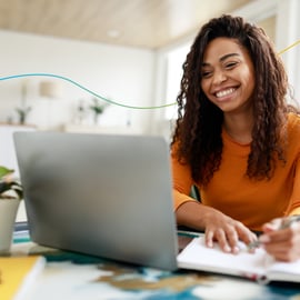 Imagery for our Skills Bootcamps in IT Sales of a young woman on her laptop smiling with a graphic line behind her