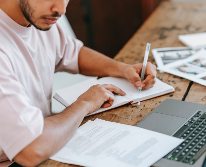 Man taking notes with a pen and notepad