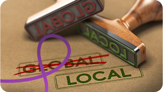 Two words stamped on a piece of paper. One word says 'Global' with a cross through it, the other word says 'Local'.