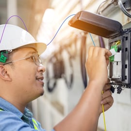 Skills Bootcamp imagery of a middle aged man fixing a telephone line