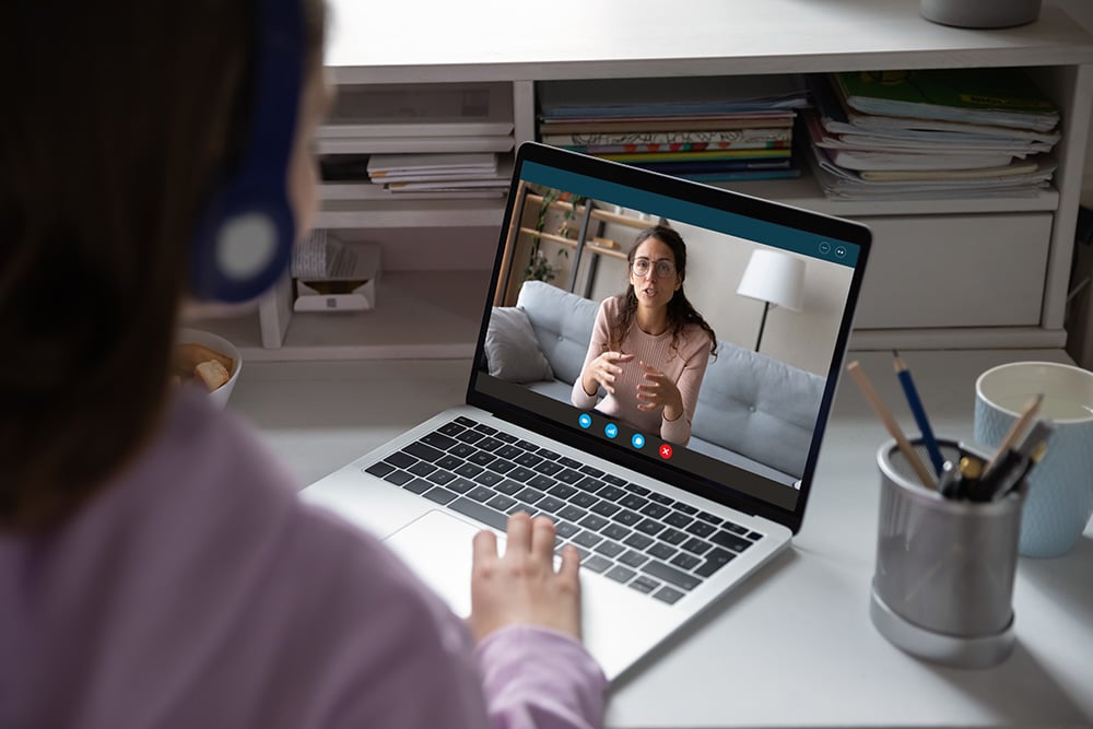 Teen girl on a video call with trainer