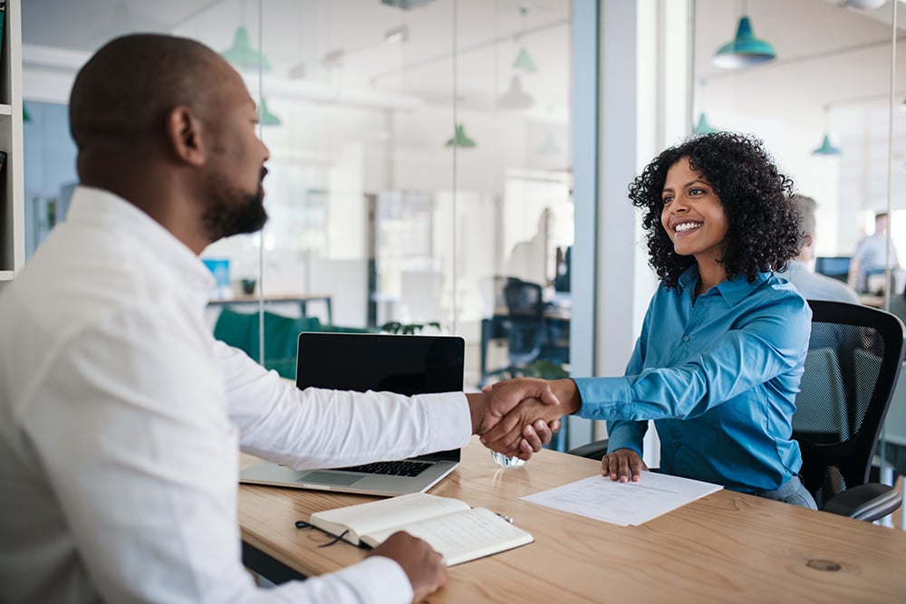Job applicant shaking hands with manager