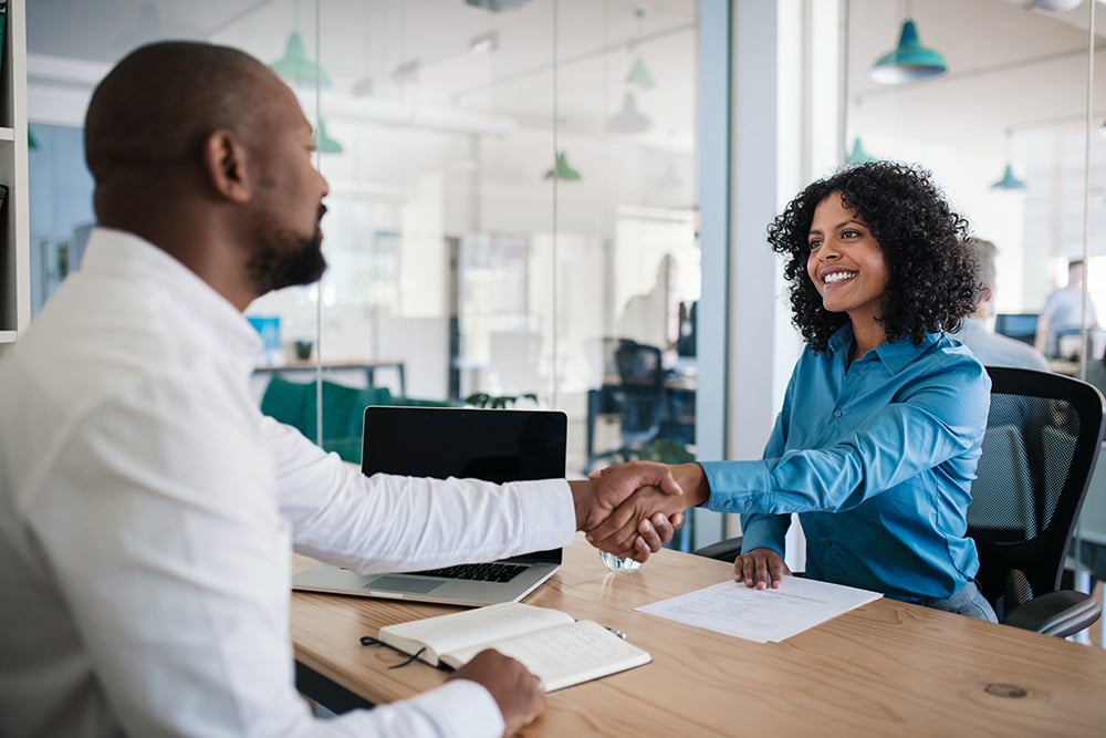 Job applicant shaking hands with manager 