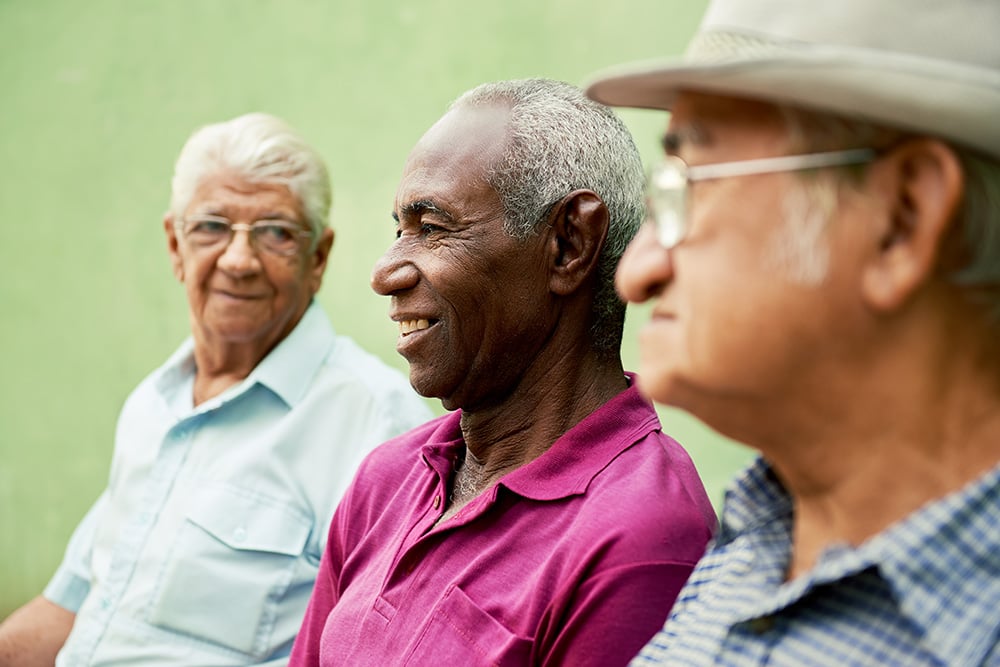 Three elderly men sat together