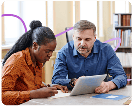 Trainer explaining how a tablet works to a student