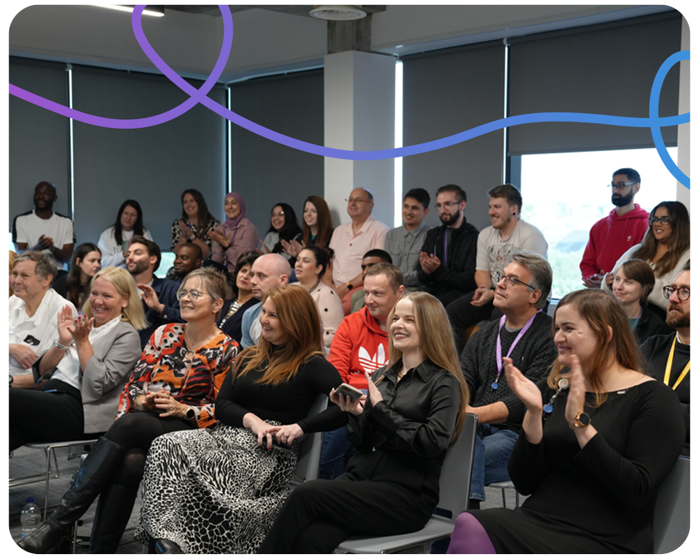 Employees from We Are Group Smiling and Clapping