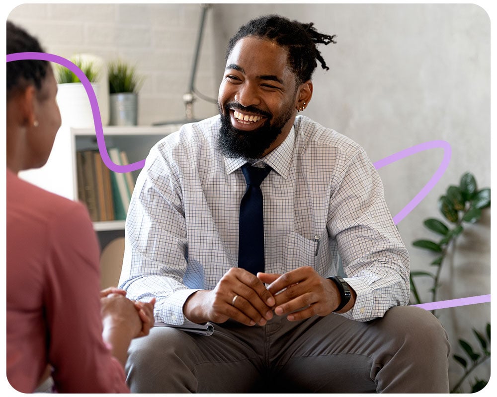 Smiling therapist meeting with client