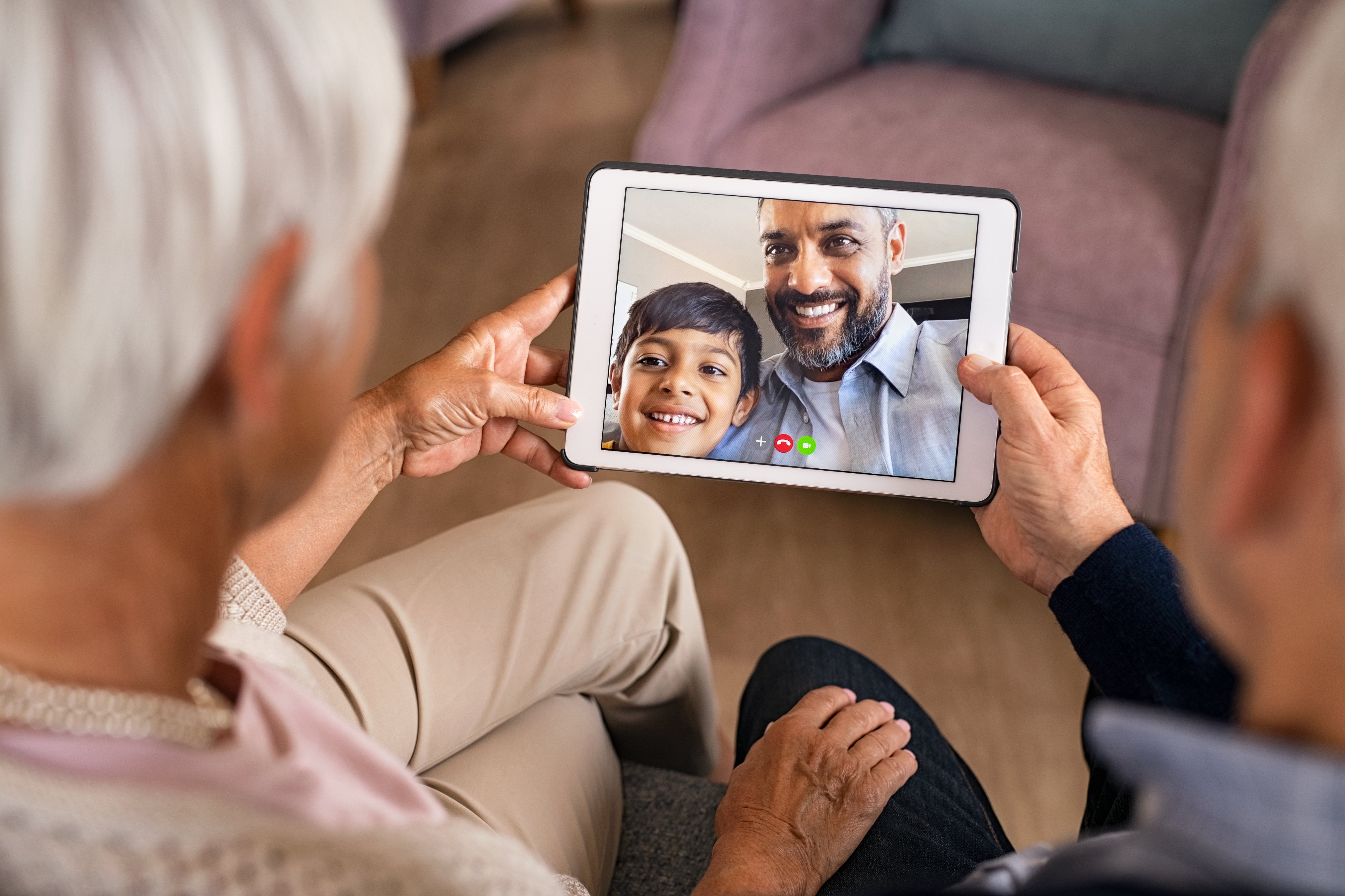 Old couple having video call with son and grandson