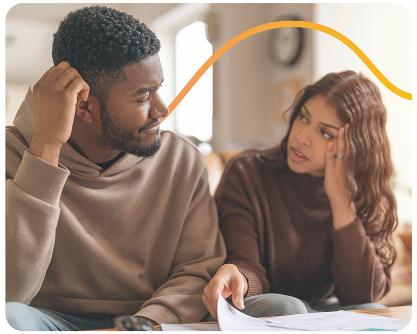 Young Couple Discussing Finances While Sitting on Couch in Living Room