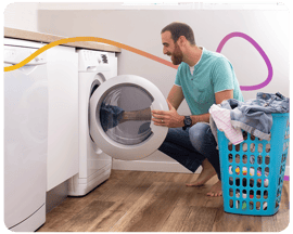 Man putting washing in washing machine